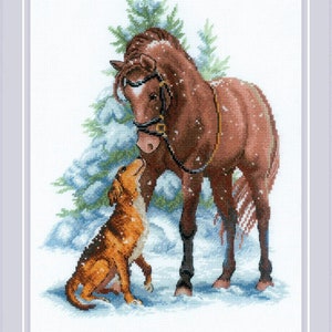 May include: A brown horse with a black bridle stands in a snowy forest with a brown and white dog sitting in front of it. The horse and dog are looking at each other.