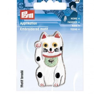 May include: White embroidered iron-on patch of a Japanese Maneki-Neko, or lucky cat, with black spots and a green bib. The cat is sitting with its right paw raised, and has a red, yellow, and black face.