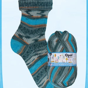 May include: A knitted sock and a ball of yarn. The sock is teal, gray, and orange striped. The yarn ball is labeled "Crazy Waters" and is teal, gray, and orange. The sock is folded over at the top.