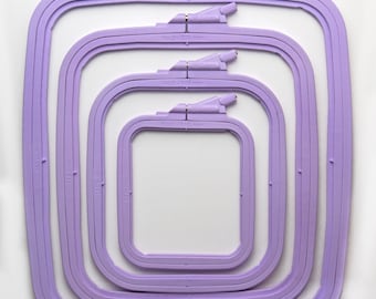 May include: Set of four purple embroidery hoops in different sizes: 110 mm, 145 mm, 195 mm, and 250 mm. The hoops are labeled with their size and number.