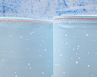 May include: Two pieces of light blue Aida cloth with a white dot pattern and a light orange border.