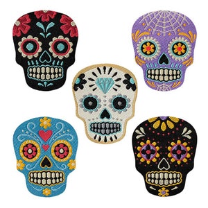 May include: Five colourful embroidered sugar skull patches. The skulls are decorated with flowers, hearts, and geometric patterns. The patches are perfect for adding a touch of Day of the Dead style to clothing, bags, or other accessories.