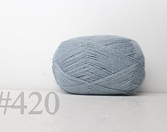 May include: A ball of light blue yarn with the number #420 printed below it.