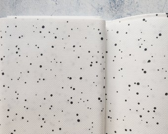 May include: White fabric with a black polka dot pattern. The fabric is folded in half, showing both sides of the pattern.