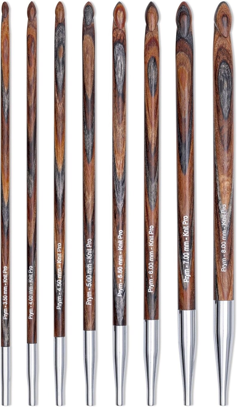 May include: Set of eight wooden knitting needles with silver tips. The needles are labeled with their size in millimeters, ranging from 3.50 mm to 8.00 mm. The needles are made by Prym and are part of the Knit Pro line.
