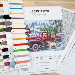 May include: A cross-stitch kit featuring a red truck with a Christmas tree and dogs in the back. The kit includes floss, a pattern, and a needle. The kit is titled "12014 Christmas Delivery".
