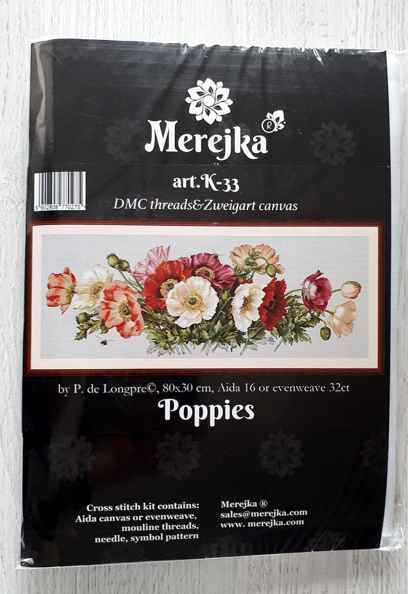 May include: Cross stitch kit featuring a colorful bouquet of poppies. The kit includes Aida canvas or evenweave, mouline threads, a needle, and a symbol pattern. The kit is by P. de Longpre and measures 80x30 cm.