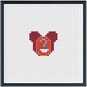 Peut inclure: Un motif de point de croix en forme de cœur rouge avec un bouclier jaune et rouge au centre. Le bouclier contient un robinet blanc à l'intérieur.