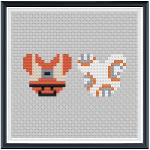 May include: A pixel art cross-stitch pattern featuring the characters BB-8 and R2-D2 from Star Wars. The characters are depicted in a heart shape.