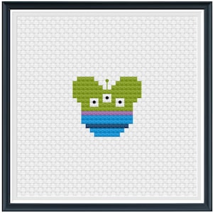 May include: A green alien head with three eyes and a purple and blue striped body in the shape of a Mickey Mouse head.