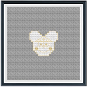 May include: A white and gold cross-stitch pattern of a cartoon mouse head with large ears and a simple smile.