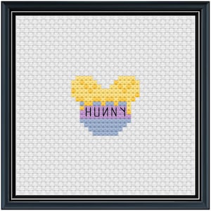 May include: A cross-stitch pattern of a blue bowl with the word "HUNNY" in purple letters and yellow honey inside.