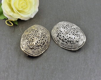 May include: Two oval-shaped brooches with intricate Celtic knotwork designs. One brooch is silver and the other is gold.