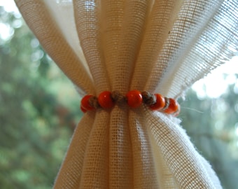 Rustic beaded jute curtain tie back with orange beads and natural jute rope. Custom made to order in various sizes. Fall holiday decor.