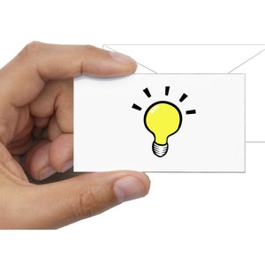 May include: A white card with a yellow light bulb illustration. The light bulb has a black outline and black lines radiating from the top.
