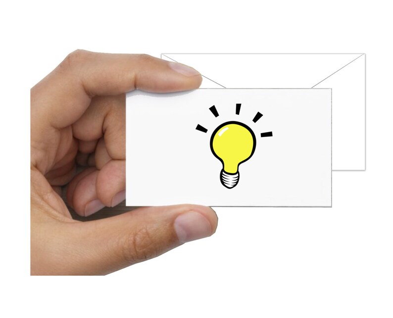 May include: A white card with a yellow light bulb illustration. The light bulb has a black outline and black lines radiating from the top.