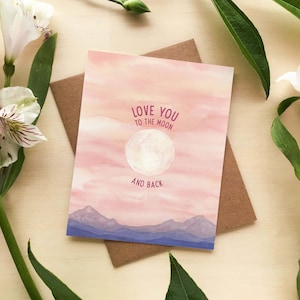 May include: A pink and yellow watercolor card with a white moon and the text "Love you to the moon and back".