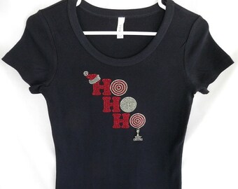 May include: Black t-shirt with a red rhinestone "HO HO HO" design and a small silver Christmas tree charm.