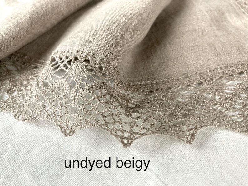 May include: Undyed beige linen fabric with a delicate crocheted lace trim. The fabric has a natural, rustic look and feel.