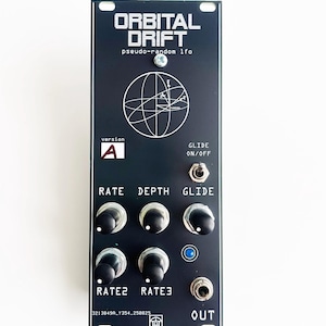 May include: Black electronic module with the text "ORBITAL DRIFT pseudo-random lfo" and a globe graphic. It has knobs and switches labeled "RATE", "DEPTH", "GLIDE", "RATE2", "RATE3", and "OUT".