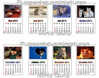 May include: A set of 12 monthly calendar cards featuring adorable kittens in various poses. Each card has a calendar for the year 2015 with the month's name and days of the week labeled. The cards are perfect for adding a touch of cuteness to your home or office.