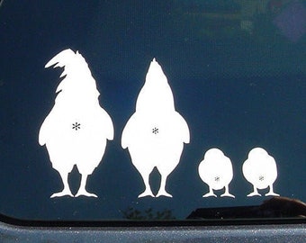 May include: A white vinyl sticker of a chicken family on a dark blue car window. The sticker shows two adult chickens and two baby chicks.