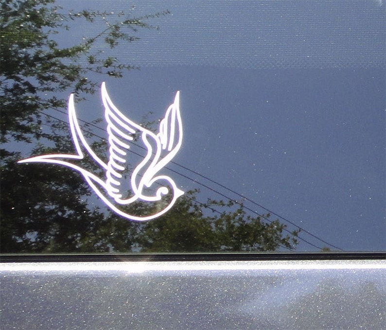 May include: A white outline of a flying bird with its wings spread, on a blue background.