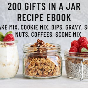 May include: Three glass jars filled with different ingredients, such as nuts, granola, and chia seeds. The jars are labeled "200 Gifts in a Jar Recipe Ebook" and list various gift ideas, including cake mix, cookie mix, dips, gravy, soups, nuts, coffees, and scone mix.