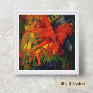 Puede incluir: Una obra de arte abstracta enmarcada con una vibrante mezcla de colores, incluyendo rojo, naranja, amarillo, verde y azul. La obra de arte mide 25,4 x 27,9 cm y está enmarcada en blanco.