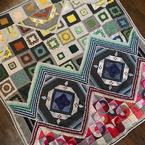 May include: A colorful crocheted blanket with a variety of geometric patterns and colors, including pink, red, blue, green, yellow, and gray.
