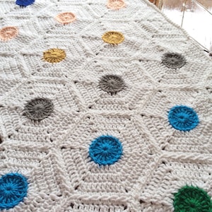 May include: White crochet blanket with a geometric pattern and colorful circles in various colors including red, blue, green, yellow, orange, and gray.