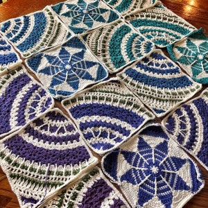 May include: A collection of crocheted squares in various patterns and colors, including blue, green, purple, and white. The squares are arranged in a grid pattern and are joined together with white yarn.