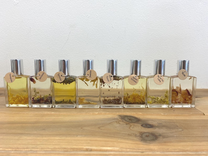 May include: Ten small glass bottles with silver caps filled with a clear liquid and dried botanicals. Each bottle has a small label with a handwritten name, including "Tangerine", "Lavender", "Rosemary", "Lemon Verbena", "Tea Tree", "Rose", and "Wild Thyme".