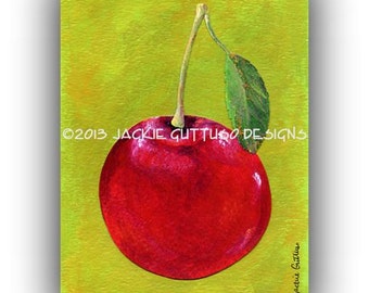 May include: A vibrant painting of a single, ripe red cherry with a green leaf and stem against a yellow-green background. The artwork includes the text "©2013 JACKIE GUTTUSO DESIGNS" and the artist's signature.