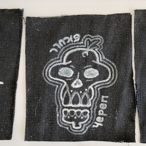 May include: Three black fabric patches with white embroidered skull designs. The first patch has a skull with a mohawk and the text "Punk-rocker". The second patch has a skull with the text "yerpen". The third patch has a skull with the text "Gorilla".
