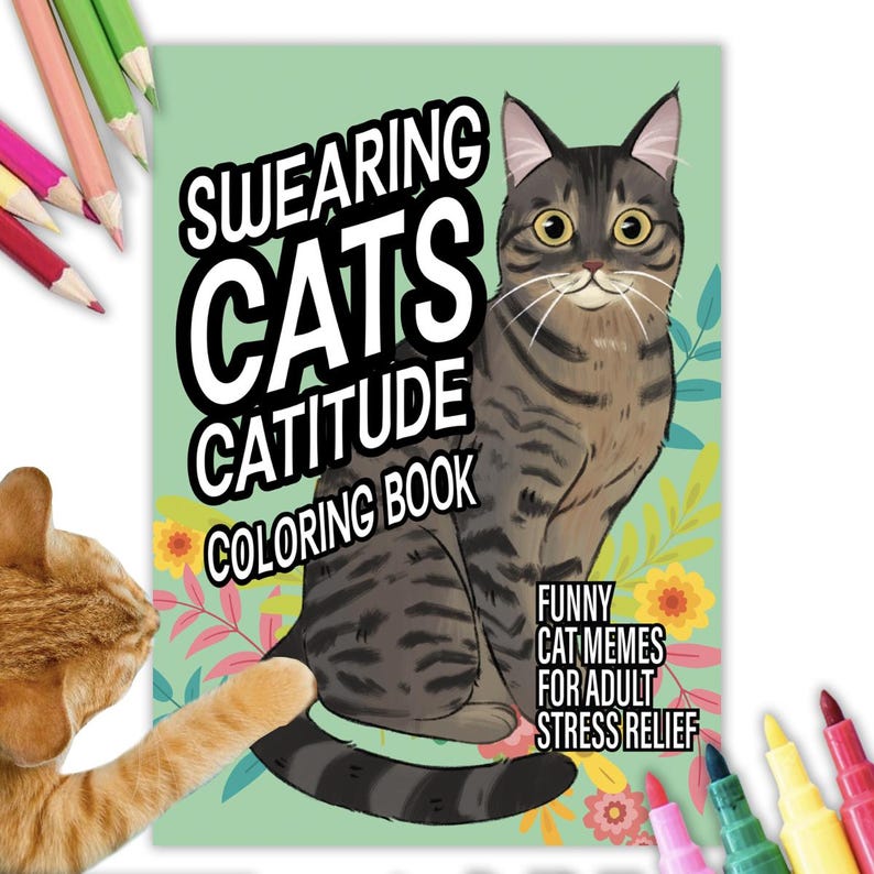 May include: A green coloring book with a cartoon cat on the cover. The book's title is "SWEARING CATS CATITUDE COLORING BOOK". The text below the cat says "FUNNY CAT MEMES FOR ADULT STRESS RELIEF".