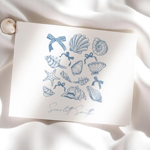 May include: A white card with a blue illustration of various seashells and a blue bow on each. The text "Scarlett Smith" is written in blue at the bottom of the card.