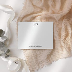May include: A white card with the initials "P.S." and the text "Paige & Samuel" printed in black.