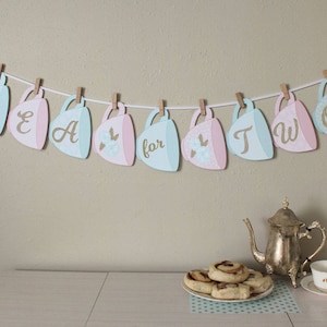 May include: A tea party banner with blue and pink teacups that reads "Tea for Two".