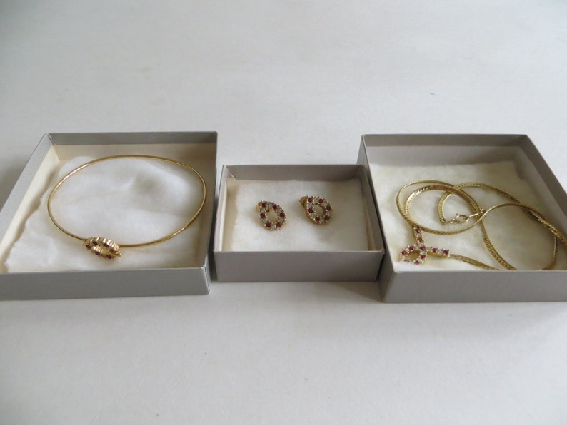 Avon Plaza Collection Red Simulated Ruby and Rhinestone Necklace Bracelet and Earrings In Original Boxes
