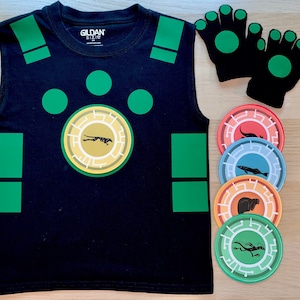 May include: Black sleeveless shirt with green squares and circles, featuring a gold circle with a black animal silhouette. Five colorful round discs with black animal silhouettes.