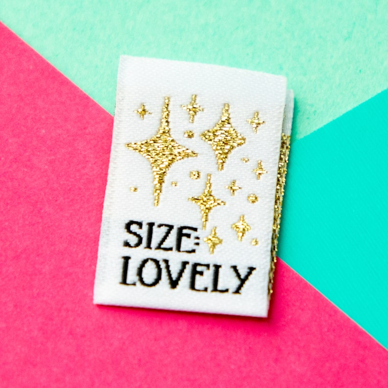 Size inclusive sew in labels for handmade or homemade items. Reads "Size: Lovely" with gold stars on it.