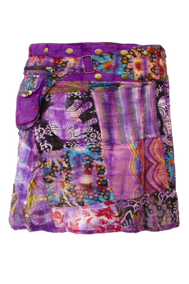 May include: A purple patchwork skirt with a tie belt and a large pocket on the side. The skirt is made of various fabrics with different patterns, including floral, paisley, and geometric designs.