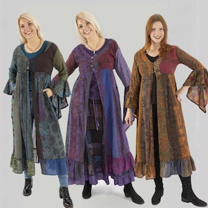 May include: Three women modeling long patchwork dresses with bell sleeves and ruffled hems. The dresses feature a variety of colors including blue, purple, brown, and green. Each dress has a unique design and button or tie closures.
