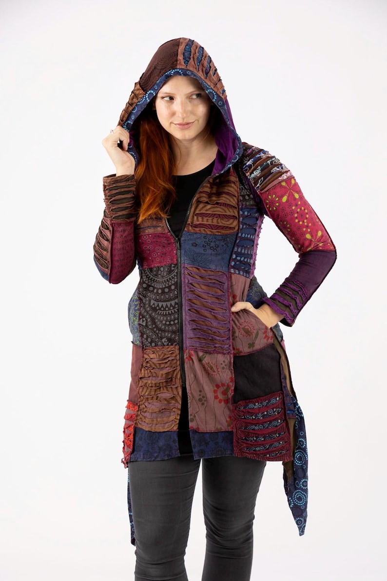 May include: A patchwork hooded jacket in shades of brown, purple, and blue. The jacket features a zip closure, pockets, and a hood with a contrasting lining. The sleeves and body are made of various patterned fabrics.