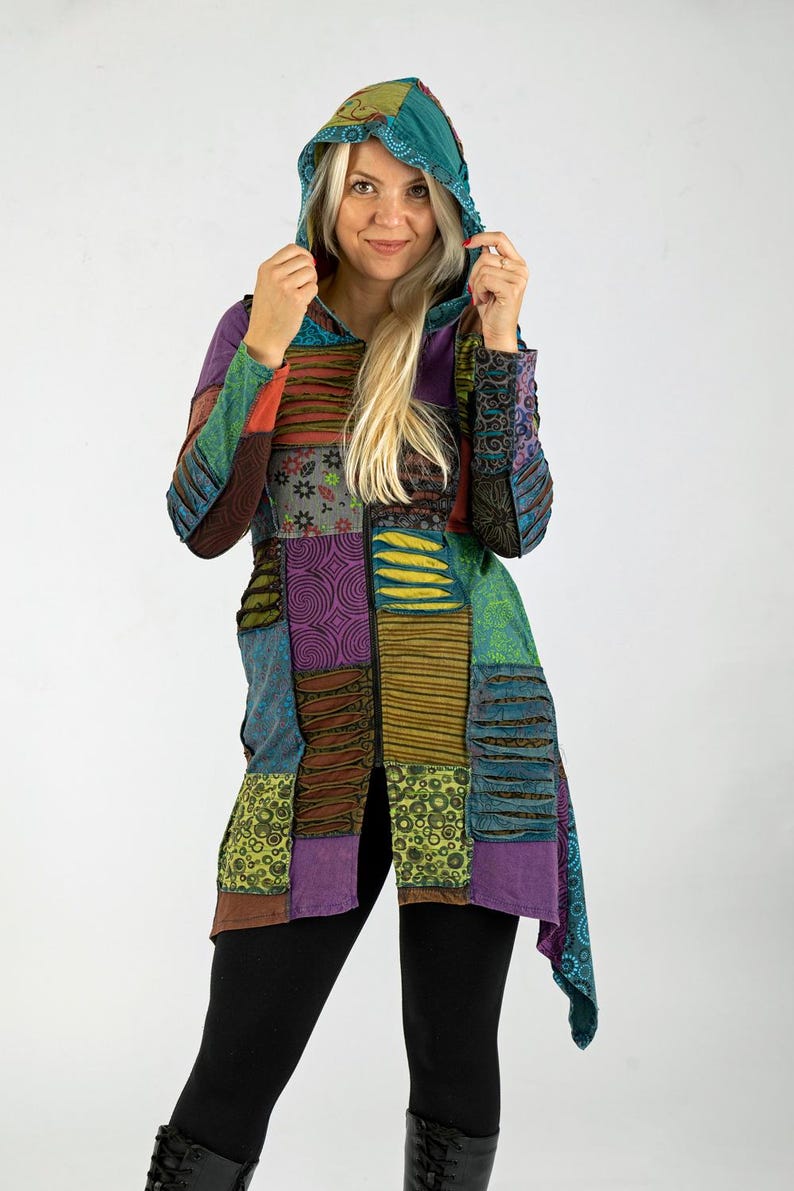 May include: A patchwork hooded jacket in various colours, including purple, green, and blue. The jacket features a mix of patterned fabrics and a long, flowing design. The hood is a solid teal colour.