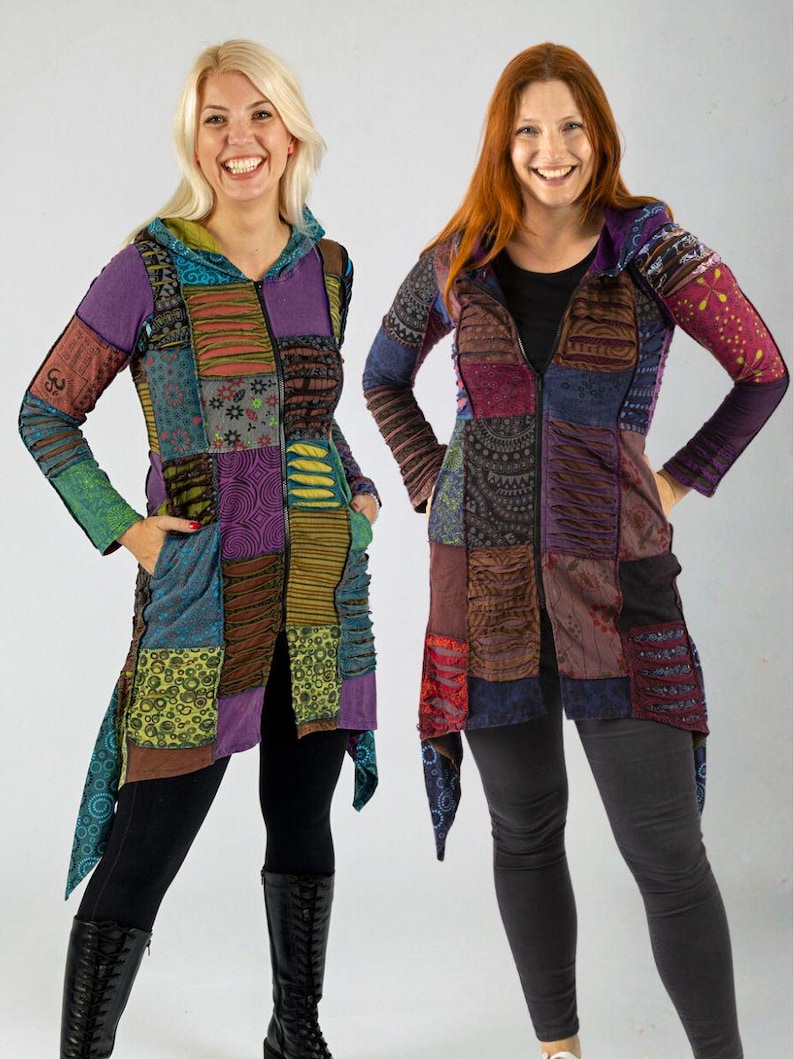 May include: Two women wearing patchwork hooded jackets in various colours and patterns. The jackets feature a zip-up front, long sleeves, and an asymmetrical hem. They are paired with black leggings and boots.