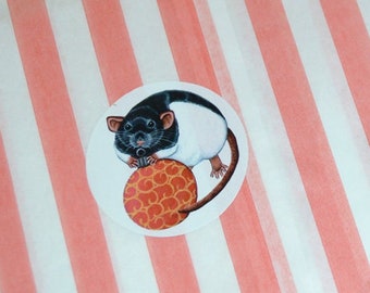 May include: A sheet of stickers with a black and white rat holding a honeycomb. The stickers are on a pink and white striped paper bag.