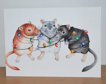 May include: Three gerbils are tangled in colorful Christmas lights. The gerbils are brown, gray, and black. The lights are strung around their bodies and tails.