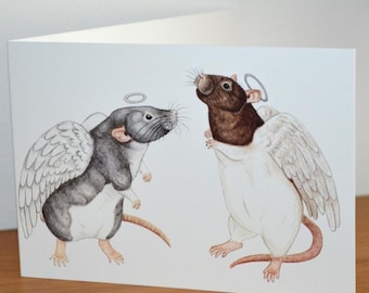 May include: A greeting card featuring a watercolor illustration of two rats with angel wings and halos. The rat on the left is black and white, while the rat on the right is brown and white.